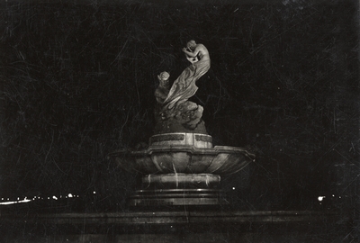 An image of a statue in New York at night