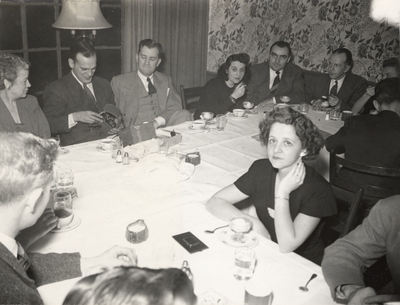 A group portrait of a party held by the Carrier Corporation. Margaret Ingels is sitting near a window on the far left of the print