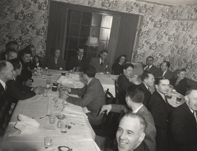 A group portrait of a party held by the Carrier Corporation. Margaret Ingels is sitting near a window on the left side of the print