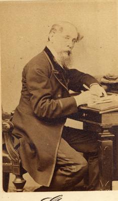 Portrait of Charles Dickens, English novelist, seated at a desk
