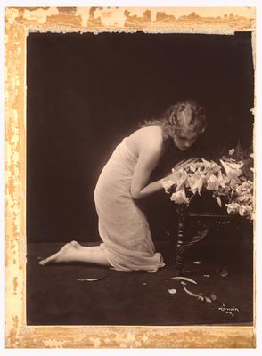 Photograph of woman kneeling as if in prayer. (Item numbers 517-519 were originally matted together in one frame. 517 on the left, 518 in center, and 519 on the right)