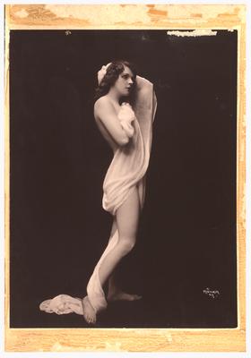 Photograph of woman standing with hand behind head draped in fabric. (Item numbers 517-519 were originally matted together in one frame. 517 on the left, 518 in center, and 519 on the right)