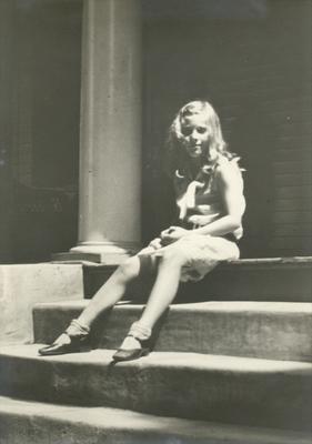 Unidentified young girl sitting on steps