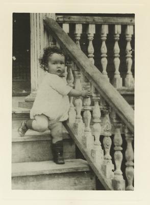 An unidentified child standing on steps