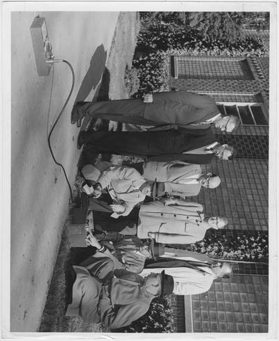 Persons connected with research density meter calibration research at the University of Kentucky watch a demonstration of one of the nuclear instruments; Kneeling from left: J. C. Cobb, Bureau of Public Roads; J. R. Harbinson, Kentucky Department of Highways; Professor L. C. Pendley, University of Kentucky Department of Civil Engineering; Standing from left: Professor David Blythe, Head of the University of Kentucky Civil Engineering Department; Professor R. E. Puckett, University of Kentucky Electrical Engineering Department; R. C. Dean, Highway Laboratory; and D. M. Burgess, Kentucky Department of Highways