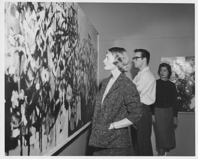 Students study a painting; Jane Thornburg on right