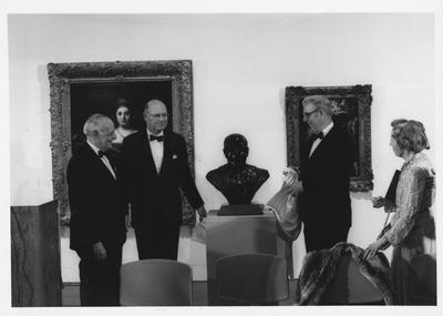 Armand Hammer, left, Bill Sturgill, second from left, and James Stewart, second from right, and Mrs. Armand Hammer admire the bust of Armand Hammer at the opening of the Armand Hammer exhibit in the Art Museum in the Singletary Center; James Stewart is the sculptor and Bill Sturgill was chairman of the University of Kentucky Board of Trustees