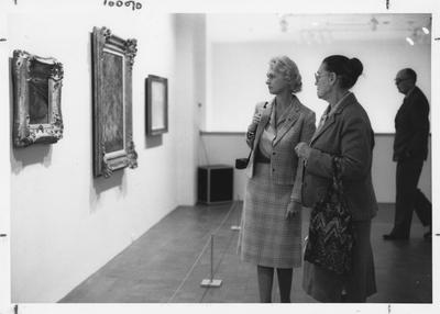 Jerlen Rose of Clay City, left; C. B. Carpenter of Stanton, right; and an unidentified man look at paintings during the opening of the Armand Hammer exhibit in the Art Museum of the Singletary Center