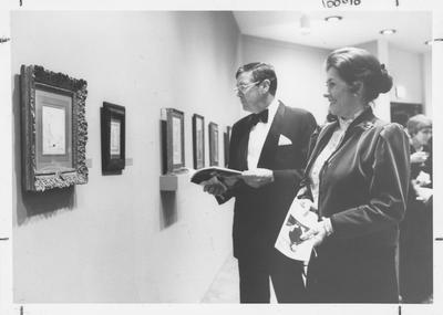Robert O. Clark (left) and Betty Pace Clark (right, Board of Trustees member) look at a drawing during the Armand Hammer exhibit in the Art Museum of the Singletary Center