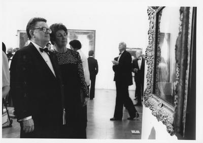 Mr. and Mrs. George Evans look at a painting during the opening of the Armand Hammer exhibit in the Art Museum in the Singletary Center