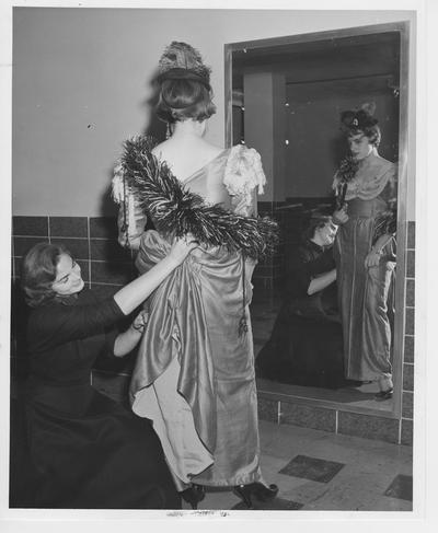 Altering a costume; Kneeling: Vicki Arrington; Standing: June McCulley