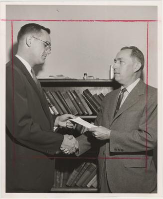 John Melyer (right) shaking hands with John Wilty (left)
