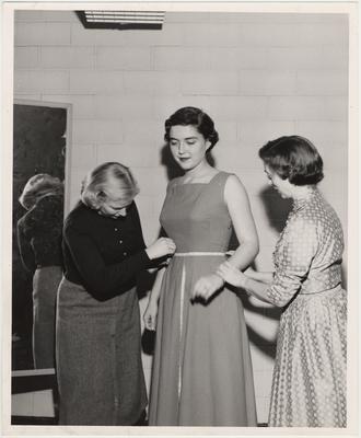 A student gets fitted for a dress