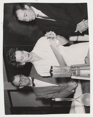 Testing berries; From left to right: Carl Chaplin, Doris Tichenor, and Dr. J. C. Rodriguez