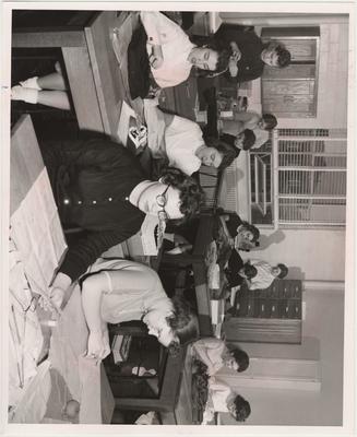 Students in a sewing class; Frances Harding at second table on left