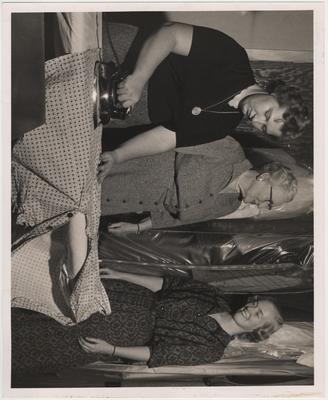 Ironing are, from left to right: Lou Ellen Russell, of Franklin, House Mother Mrs. Ethyl Squires, and Lynn Cratcher
