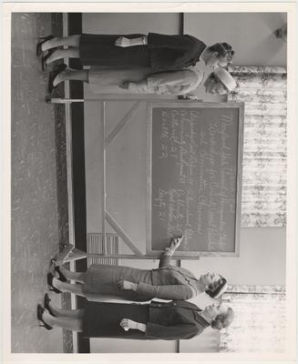 Women check the board for workshops for County Council (Maryland) Presidents and Committee Chairmen