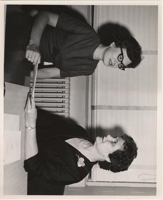 Roberta Taylor (right) awards a scholarship to an unidentified woman