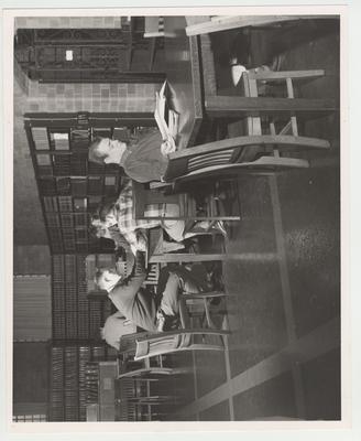 Law Library; First table: Jim Prater; From left to right, Second table: John Morgan, George Shadoan, and Bill Priest (back to camera)