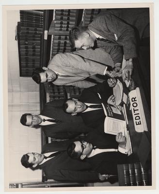 Editorial Board for the Law Journal; Seated from left: Linza Inabnit, Lawrenceburg, editor - in - chief; Robert E. Adams, Salyersville, associate editor; and Fred Bradley, Providence, comment editor; Standing: James H. Birdwell, Shelby County, note editor; Professor Tom Lewis, faculty editor; and Arthur L. Brooks, Jr., Cave City, comment editor