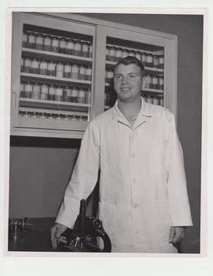 Mr. Rose stands in Pharmacy lab