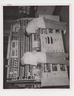 Men work in the Pharmacy dispensing laboratory