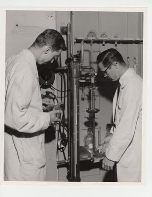 Billy Howard Smith (left) and Dr. J. William Miles (right) work in the Pharmacy lab