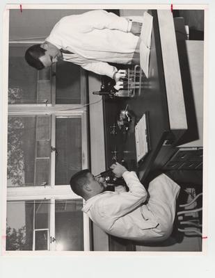 Pharmacy students using microscopes