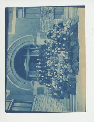 Women sit in front of the Gillis Building