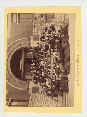 Women sit in front of the Gillis Building