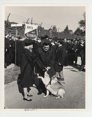 Students of the College of Arts of Sciences (including a seeing eye dog wearing a graduation cap) at graduation ceremonies; This image is on page 134 of the 1969 Kentuckian