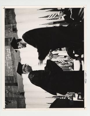 A student receives his diploma in Memorial Coliseum; This image is on page 135 of the 1969 Kentuckian