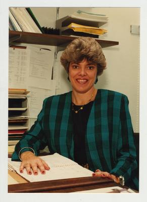 An advisor sits at her desk