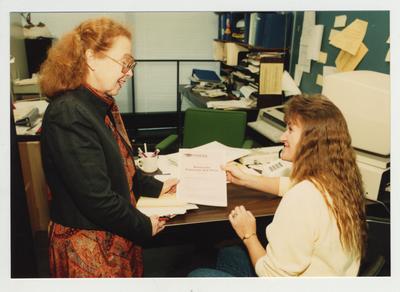 A woman informs a female student about KHEAA Kentucky Financial Aid in her office at Ashland Community College