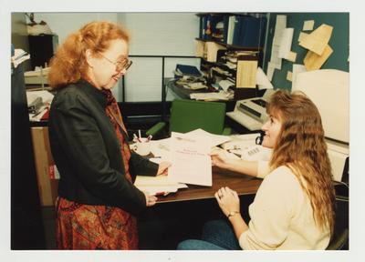 A woman informs a female student about KHEAA Kentucky Financial Aid in her office at Ashland Community College