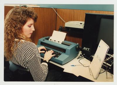 A female student types at Ashland Community College