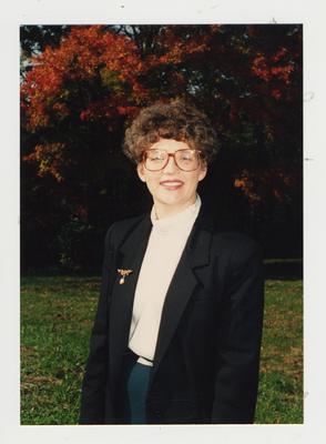 An unidentified woman framed by the Fall foliage