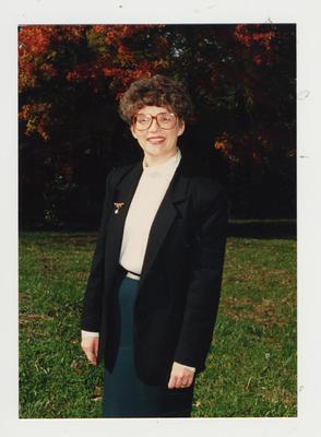 An unidentified woman framed by the Fall foliage