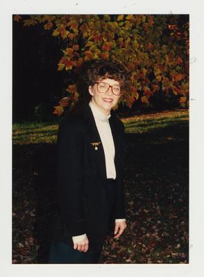 An unidentified woman framed by the Fall foliage