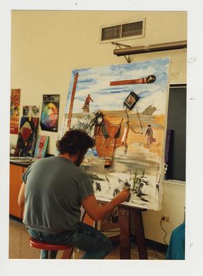 Unidentified male student paints in a classroom at Ashland Community College