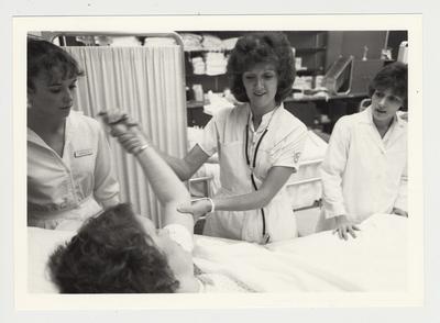 Nurses help an unidentified woman in the hospital