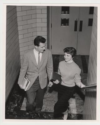 David Jones and Rosamond Nell Haskell at the bottom of a staircase