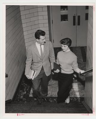 David Jones and Rosamond Nell Haskell at the bottom of a staircase