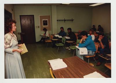A female professor lectures in a classroom