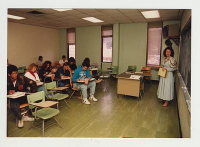 A female professor lectures in a classroom