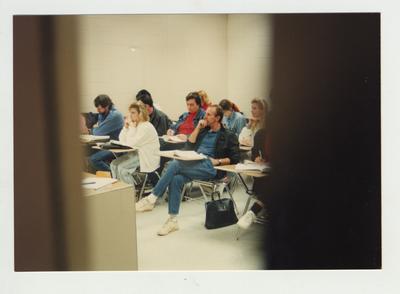 Students listen and take notes during a classroom lecture