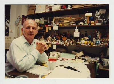 Professor Robert McAninch sits at the desk in his office