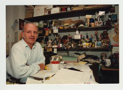 Professor Robert McAninch sits at the desk in his office