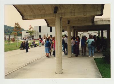 Students stand around an unidentified building