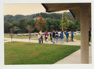 Students stand around an unidentified building